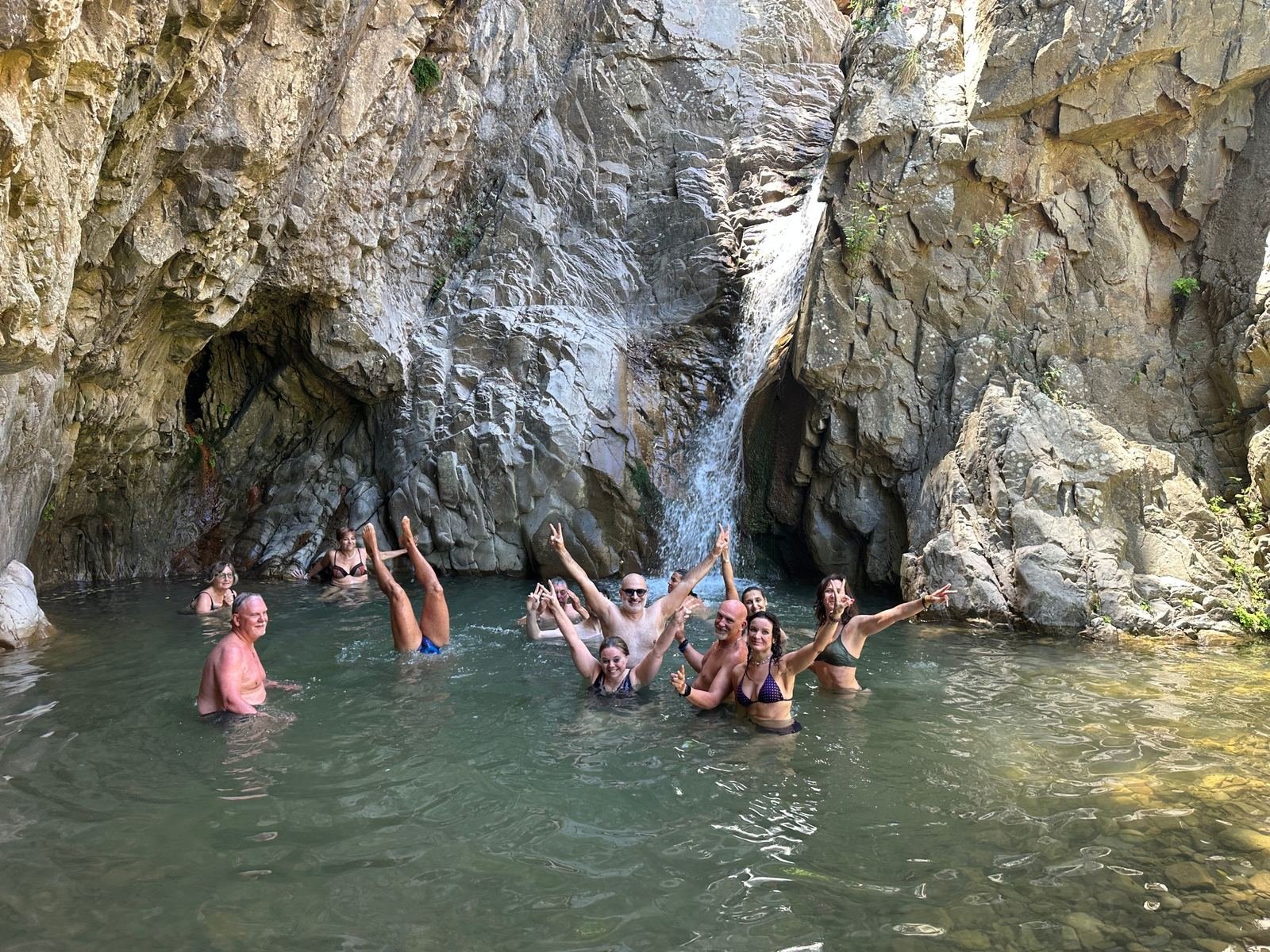Il gruppo di Epic Routes Community fa il bagno nella pozza sotto le Cascate di Mistretta, tra pareti di roccia